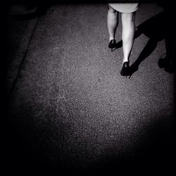 Low section of woman standing on tiled floor