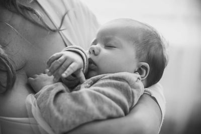 Close-up of young woman holding baby boy