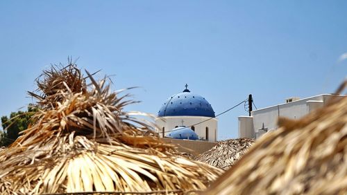 Low angle view of traditional building against clear blue sky