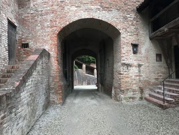 Empty alley amidst buildings in city