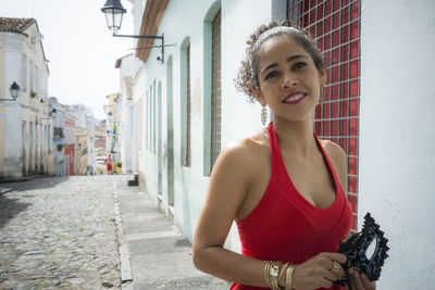 Portrait of a woman wearing red dress on a street. salvador, bahia, brazil.