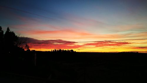 Scenic view of silhouette landscape against sky during sunset