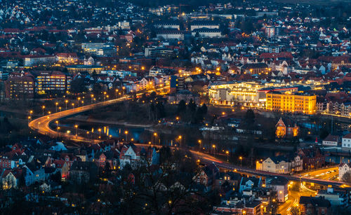 High angle view of city lit up at night