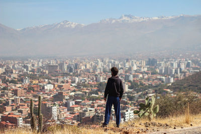 Rear view of man standing on mountain