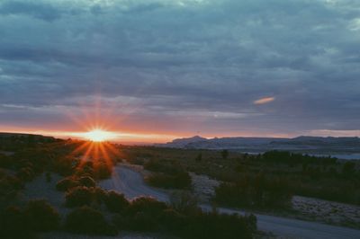 Scenic view of landscape against cloudy sky