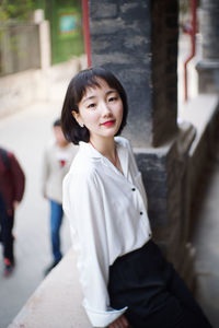 Portrait of beautiful young woman standing outdoors