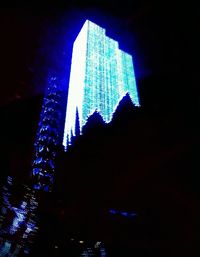 Low angle view of modern building against sky at night