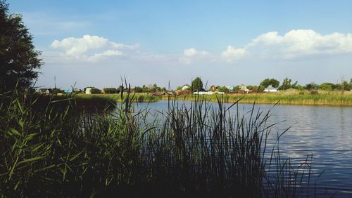 Scenic view of lake against cloudy sky