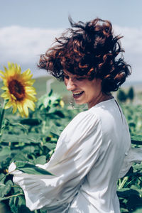 Side view of woman against white flowering plants