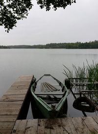 Pier over lake against sky