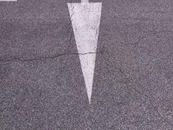 High angle view of arrow symbol on road