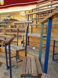 Empty chairs and table in row