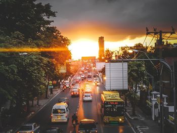 Traffic on city street during sunset