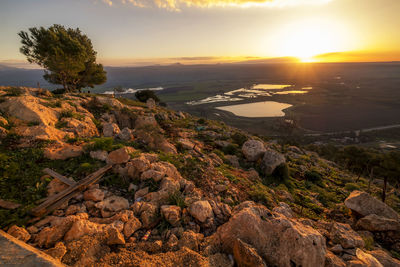 Scenic view of rocks against sky during sunset