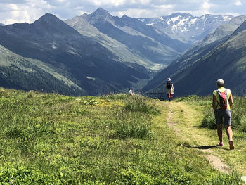 Rear view of women walking on mountain road