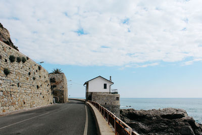 Road by sea against sky