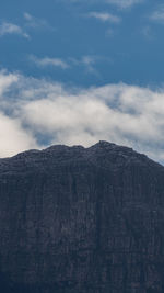 Low angle view of rocky mountains against sky