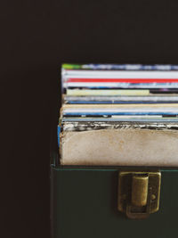 Close-up of open book on table against black background