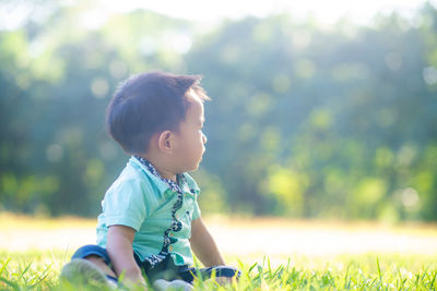 Cute boy looking away on field