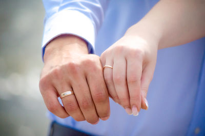 Couple touching hands together outdoors