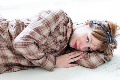 Portrait of woman lying on floor