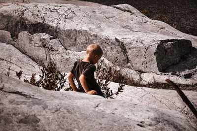 Woman sitting on rock