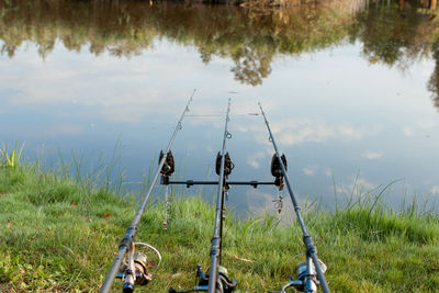 Panoramic view of fishing rod at lakeshore