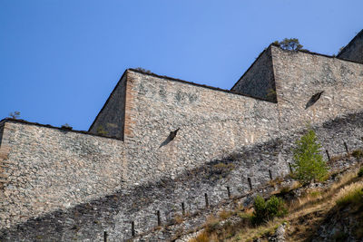 Low angle view of building against clear blue sky