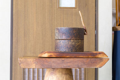 Close-up of rusty metal on wooden table