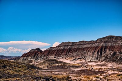 Scenic view of mountains against blue sky