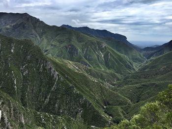 Scenic view of green mountains against sky