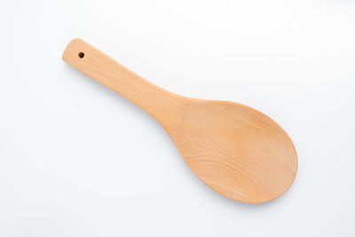 Directly above shot of wooden spoon on white background