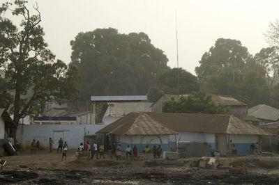 People in front of built structure against sky