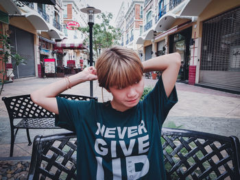 Portrait of boy standing in city