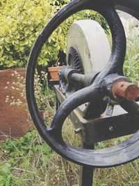 Close-up of bicycle wheel on field