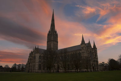 The silhouette of salisbury cathedral at sunset in wiltshire, uk