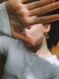 Woman gesturing stop sign at home