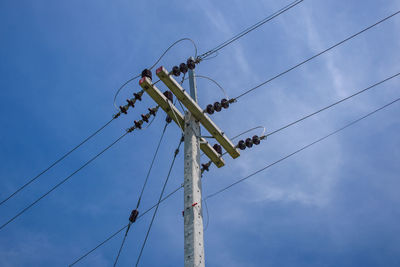 Low angle view of electricity pylon against sky