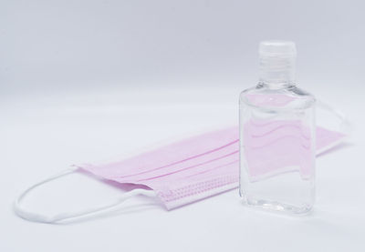 Close-up of water bottle on table against white background