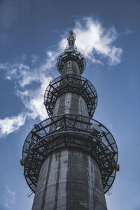 Low angle view of water tower against cloudy sky