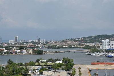 River by cityscape against sky