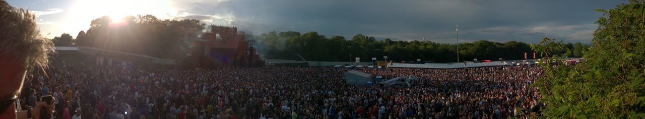 Crowd on field against sky