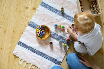 High angle view of sisters playing with toys at home