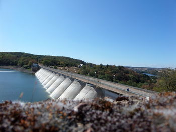 Scenic view of dam against clear blue sky