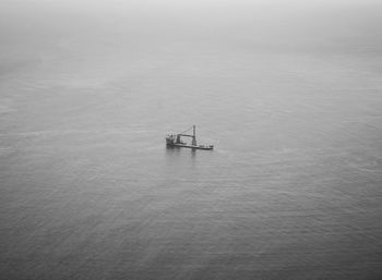 Ship sailing on sea against sky