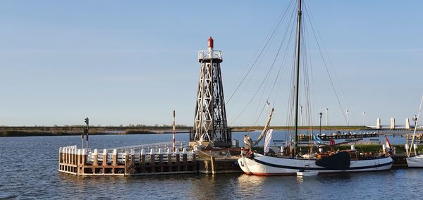 Ships moored in port near the lighthouse.