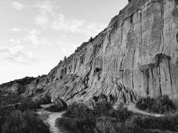 Low angle view of rock formations against sky