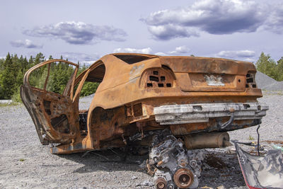 Abandoned truck on field against sky