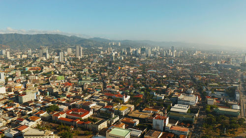 High angle view of city buildings against clear sky