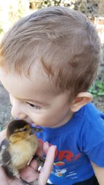 Close-up of cute boy holding outdoors